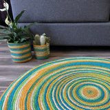 Colorful round jute rug featuring a concentric design on a wooden floor.