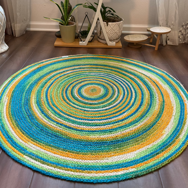 Colorful round jute rug featuring concentric spiral design. Eco-friendly, reversible, and vegan area rug.